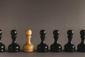 Line of black pawns with one white inside