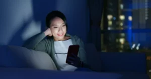 Woman use of mobile phone at night